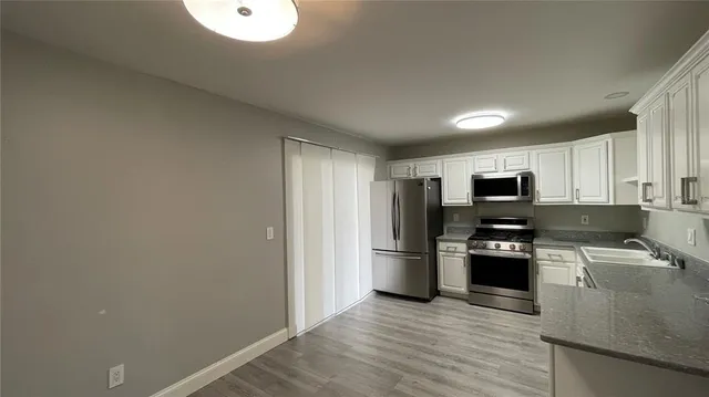 a kitchen with stainless steel appliances a refrigerator stove and sink
