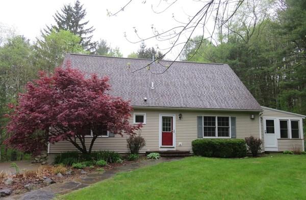 a view of a house with a yard and a garden