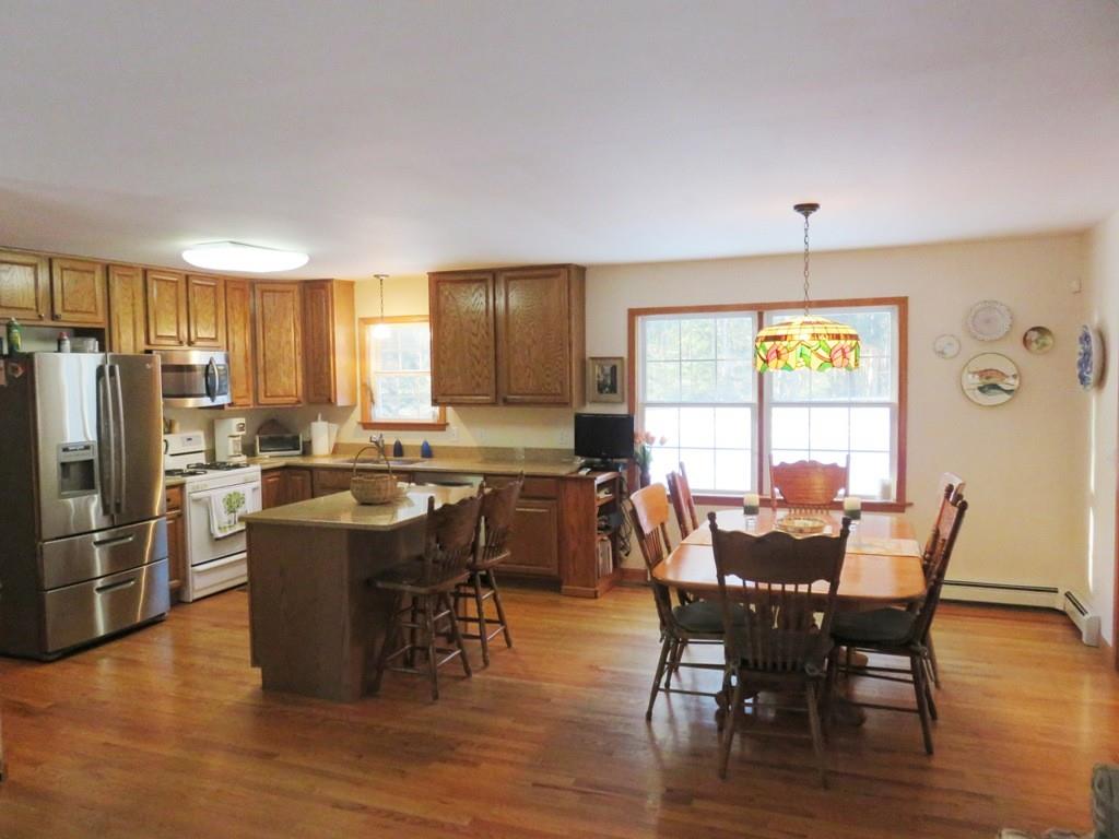 124 Werden Road Otis, MA 01253 - Photo 3 of 14 a view of a dining room with furniture window and wooden floor