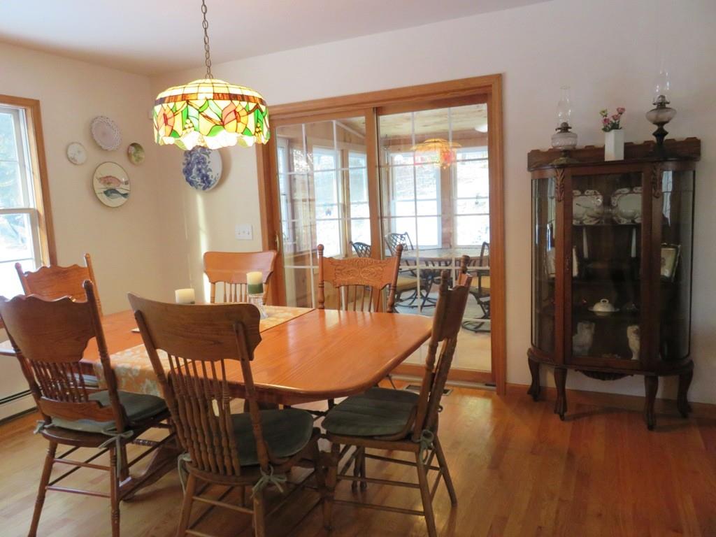 124 Werden Road Otis, MA 01253 - Photo 4 of 14 a view of a dining room with furniture wooden floor and chandelier