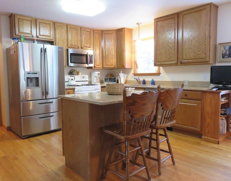 124 Werden Road Otis, MA 01253 - Photo 5 of 14 a kitchen with stainless steel appliances a refrigerator a sink a stove a table and chairs