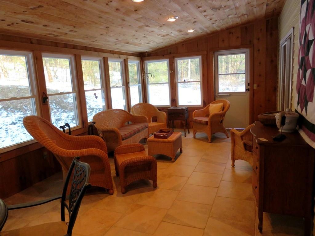 124 Werden Road Otis, MA 01253 - Photo 6 of 14 a living room with furniture and a floor to ceiling window
