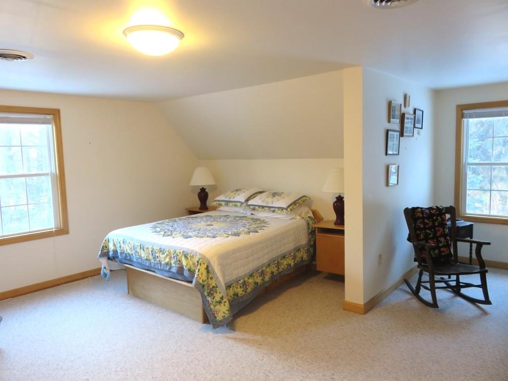 124 Werden Road Otis, MA 01253 - Photo 10 of 14 a bedroom with a bed and a chair