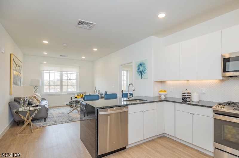 558 Market Street Newark, NJ 07105 - Photo 5 of 17 a kitchen with a sink stove and cabinets