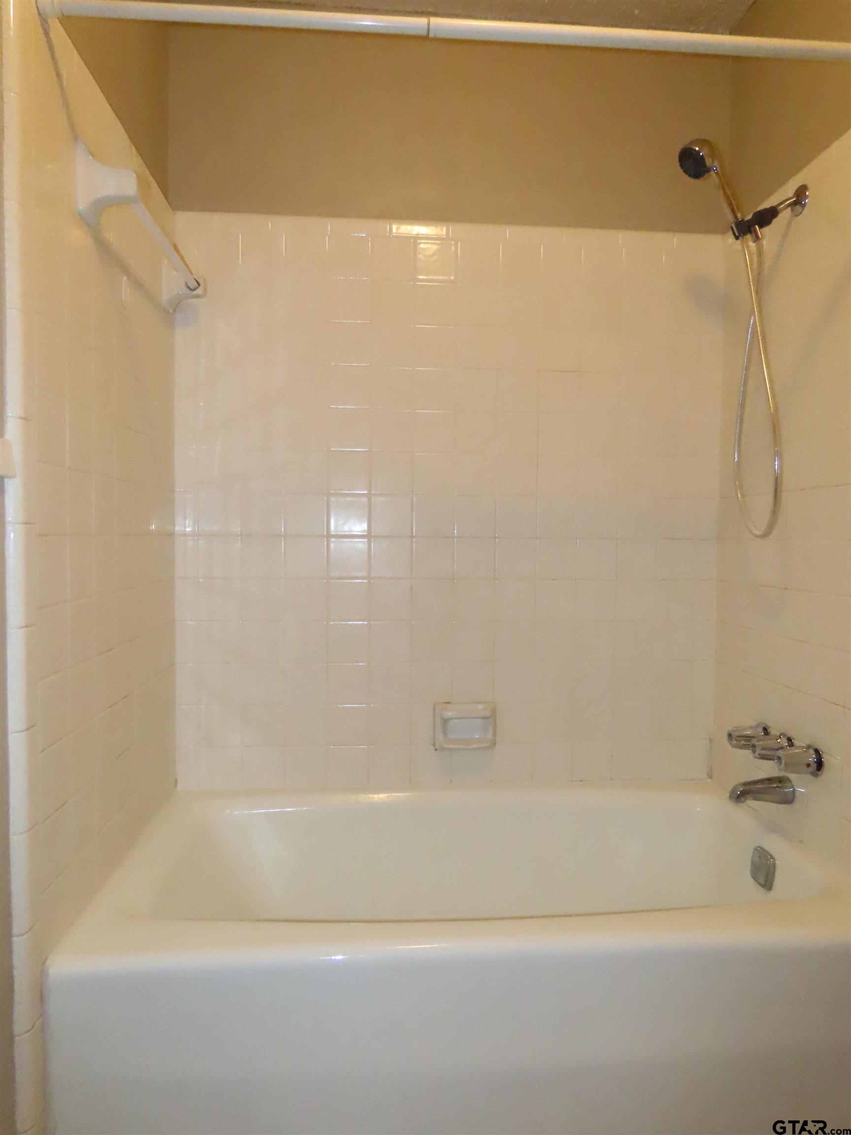 402 Muller Garden Road Tyler, TX 75703 - Photo 19 of 33 a bathroom with a shower and a bath tub