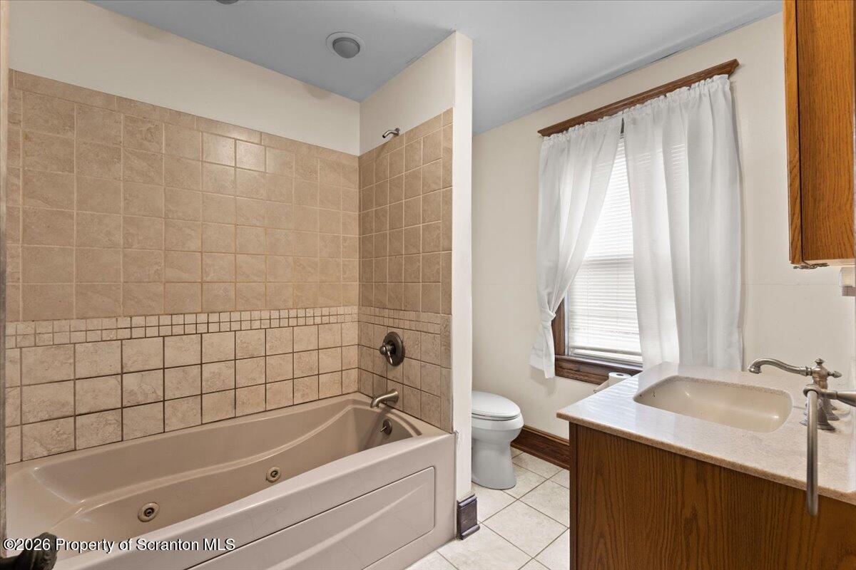 1441 Sanderson Avenue Scranton, PA 18509 - Photo 13 of 33 a bathroom with a tub a sink and a window