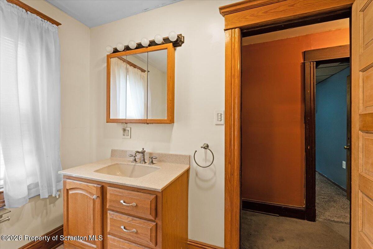 1441 Sanderson Avenue Scranton, PA 18509 - Photo 14 of 33 a bathroom with a sink and a mirror