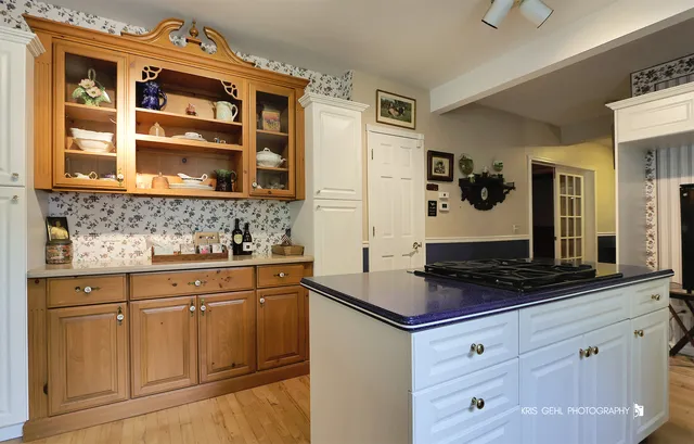 a kitchen with granite countertop white cabinets and stainless steel appliances