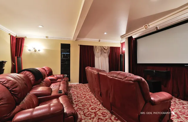 a living room with furniture a projector and flat screen