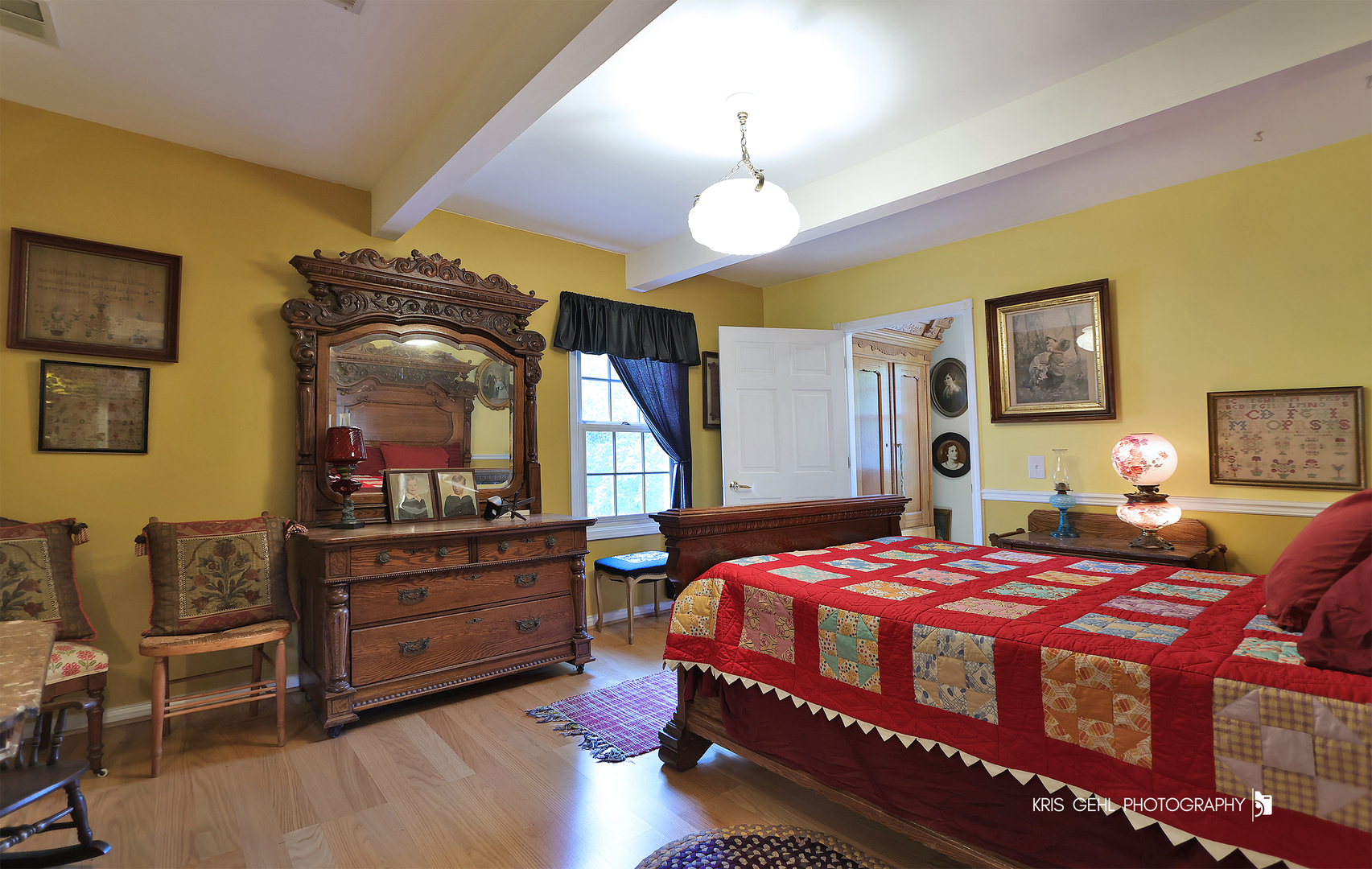2214 Main Street Road Spring Grove, IL 60081 - Photo 27 of 53 a bedroom with a bed a chandelier with dresser and mirror