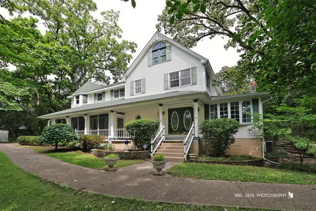 a front view of a house with a yard and potted plants