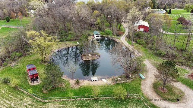 an aerial view of a house with a yard basket ball court and outdoor seating