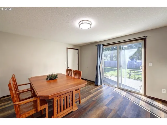 a kitchen with refrigerator cabinets and wooden floor