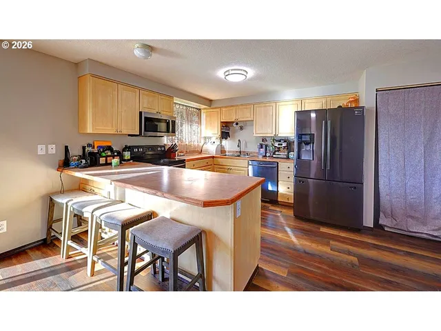 a view of a dining room kitchen counter space and a view of living room