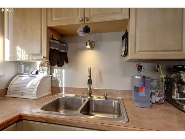 a kitchen with a sink a stove cabinets and a refrigerator
