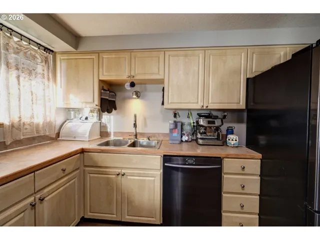 a kitchen with stainless steel appliances a refrigerator and a stove top oven