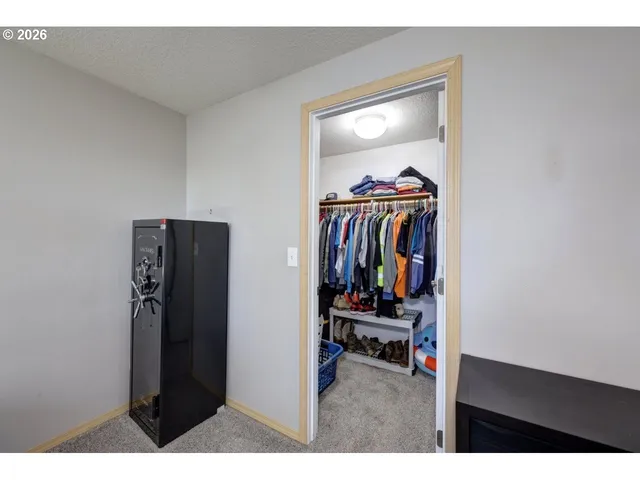a bedroom with a bed window and dresser