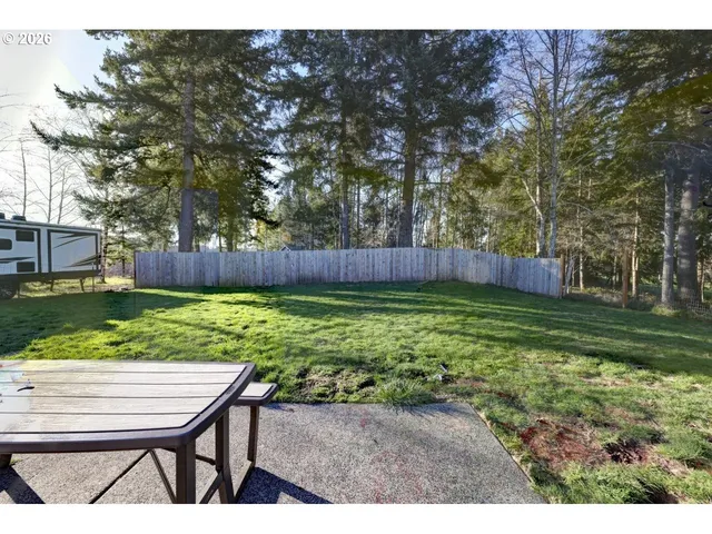 a living room with furniture a rug and a window