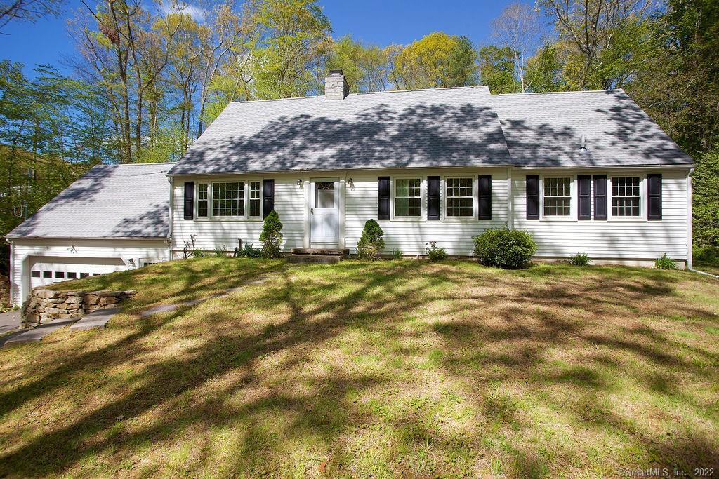 This charming cape cod is perfectly situated on a private 1.8 acre lot.
