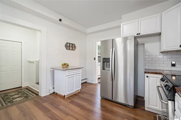 a kitchen with a refrigerator and a stove top oven