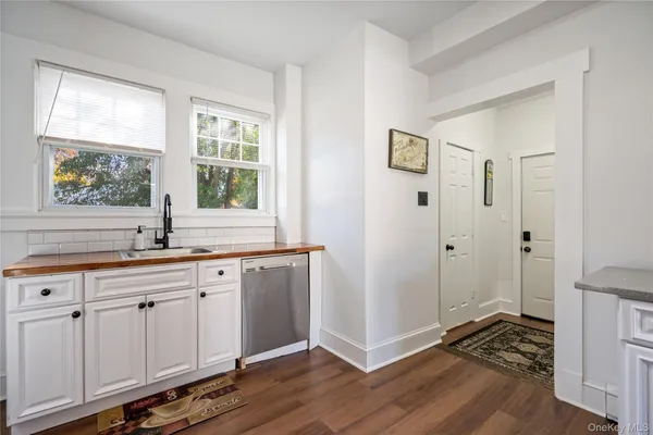 a hallway with sink and wooden floor