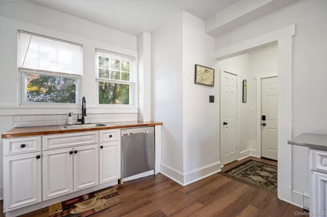 a hallway with sink and wooden floor