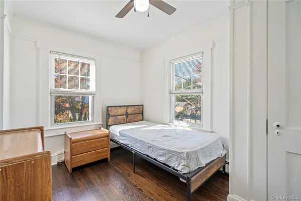 a bedroom with a bed window and a dresser