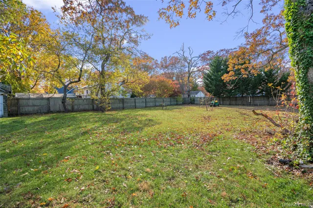 a view of a yard with a house in the background