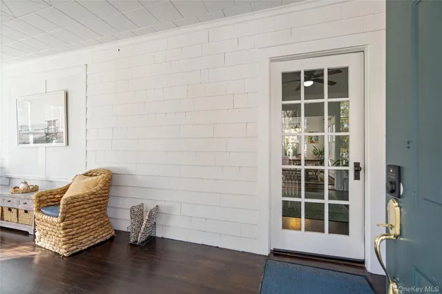 a view of empty room with wooden floor and windows