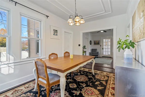 a very nice looking dining room with furniture and a chandelier