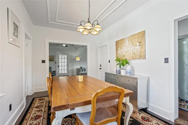 a dining room with furniture and a chandelier