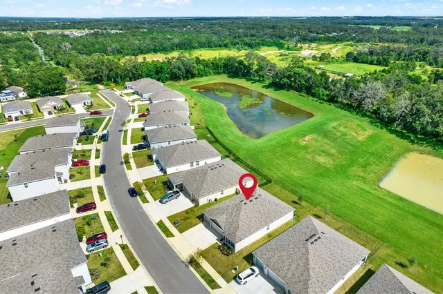 a aerial view of a house with a yard and garage