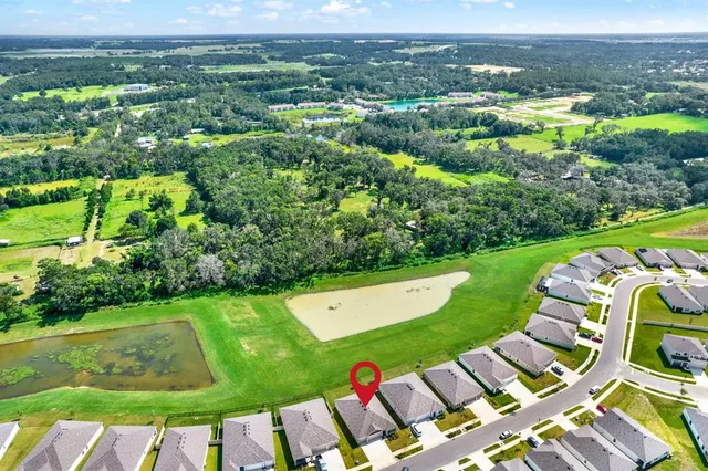 a aerial view of a house with a yard table and chairs