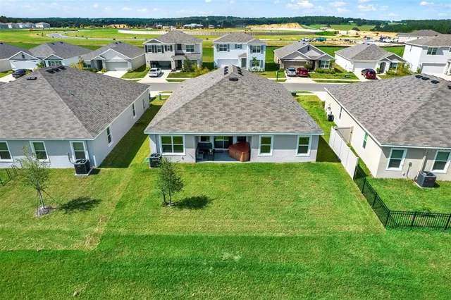a view of a big yard with a table and chair