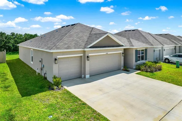 a kitchen with sink a microwave and cabinets
