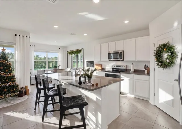 a dining room with furniture and large windows