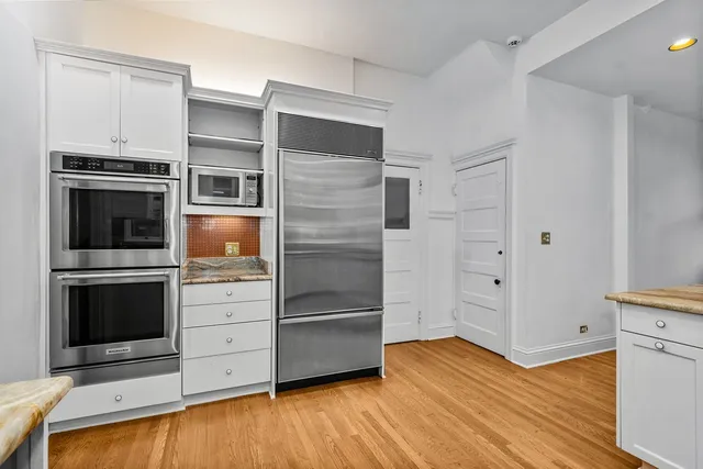 a kitchen with stainless steel appliances and cabinets
