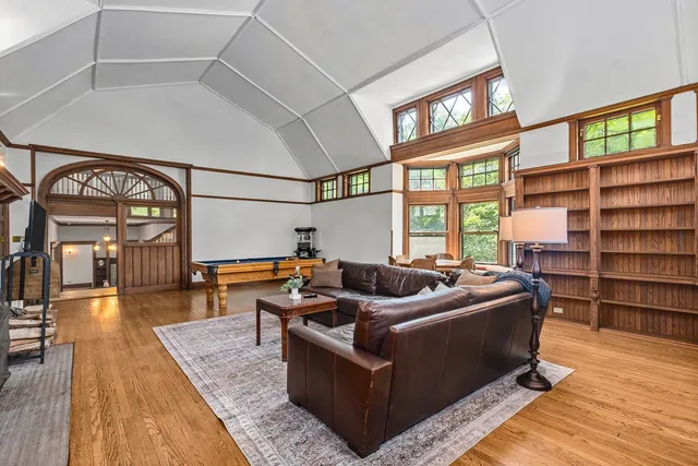 a living room with furniture fireplace and a window