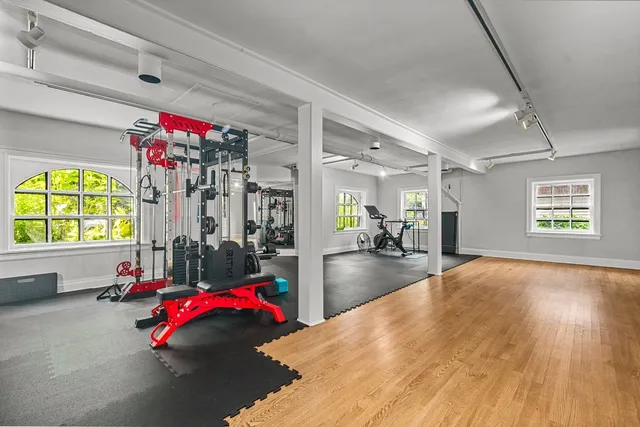 a living room with furniture and a floor to ceiling window