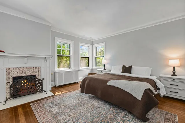 a spacious bedroom with a bed and a fireplace