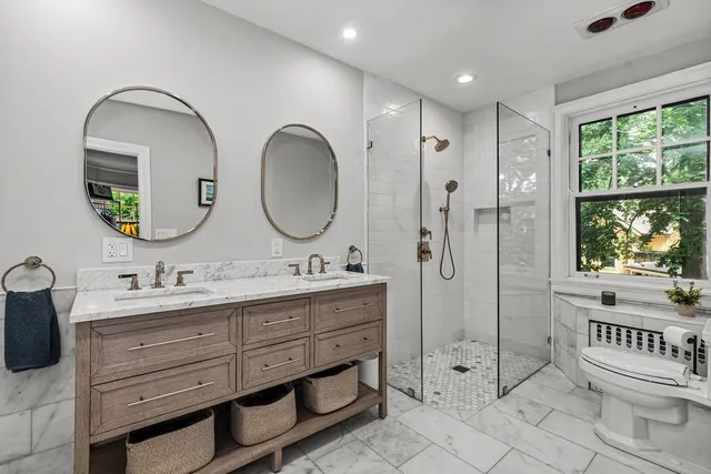 a bathroom with 2 sink tub and a mirror