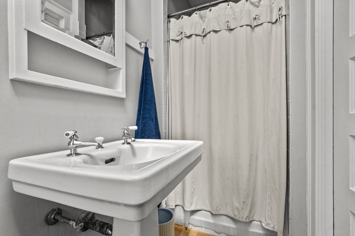 225 Hamilton Street Evanston, IL 60202 - Photo 28 of 38 a bathroom with a sink and a mirror