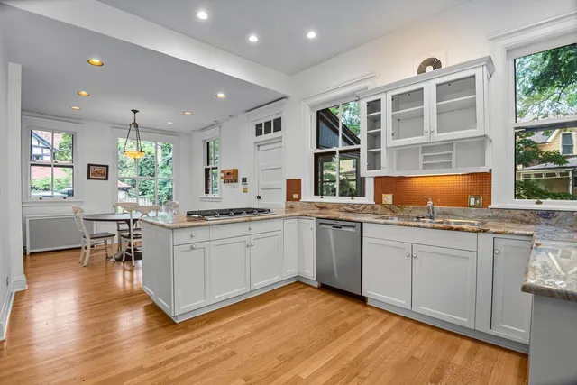 a kitchen with granite countertop a sink and cabinets