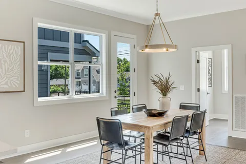 a dining room with furniture and window