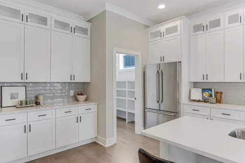 a kitchen with a refrigerator sink and cabinets