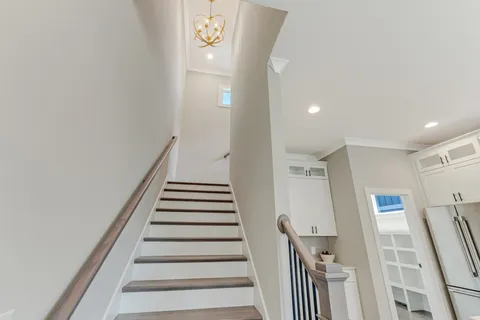 a view of staircase with white walls and a window