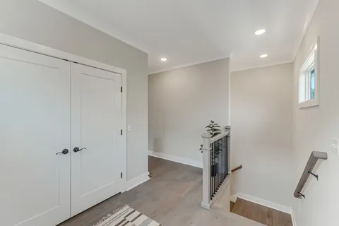 a view of hallway with wooden floor