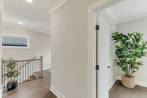 a living room with furniture a window and a potted plant