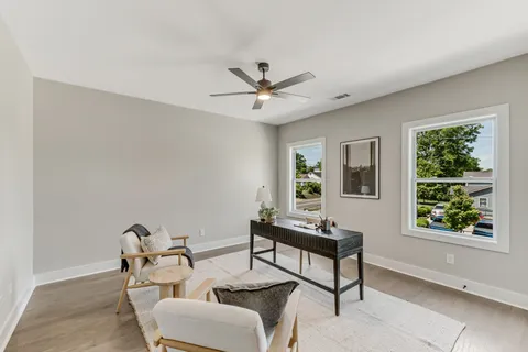 a view of a livingroom with furniture and a potted plant