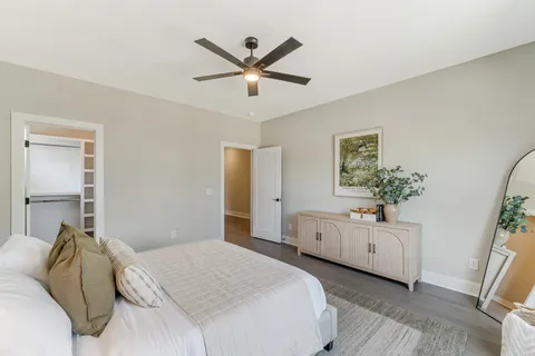 a spacious bathroom with a double vanity sink a large mirror and shower